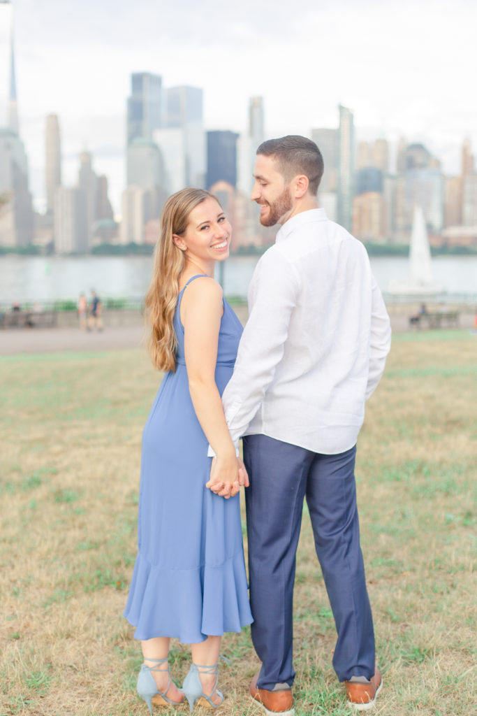 light and airy engagement photo in front of nyc skyline