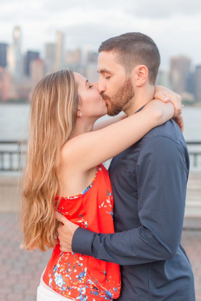 light and airy kissing engagement photo