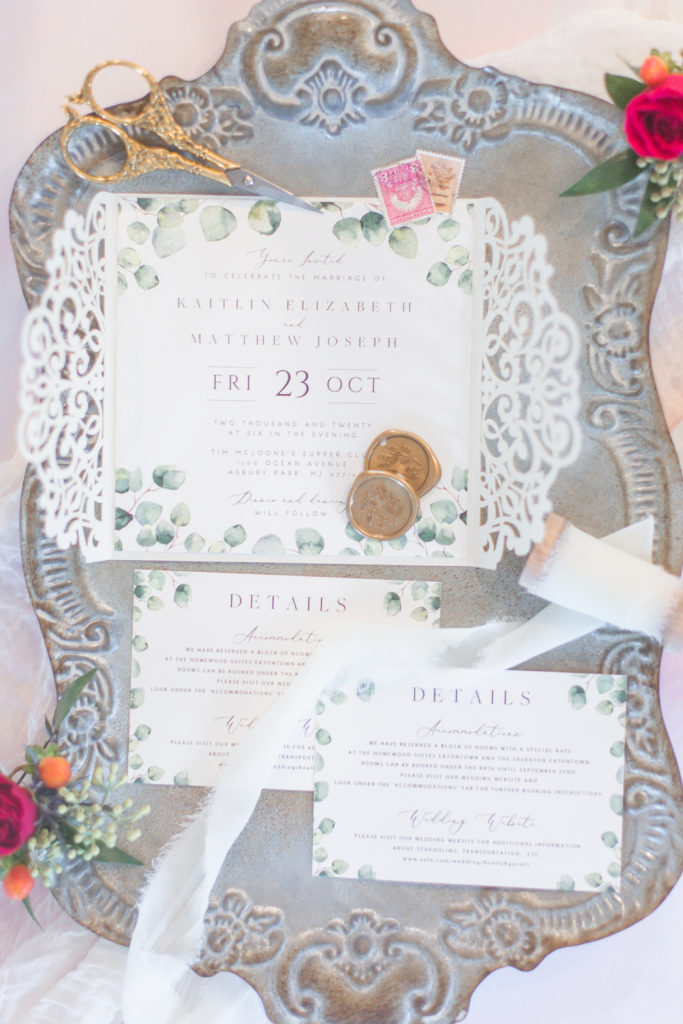 wedding invitation flatlay on antique silver tray