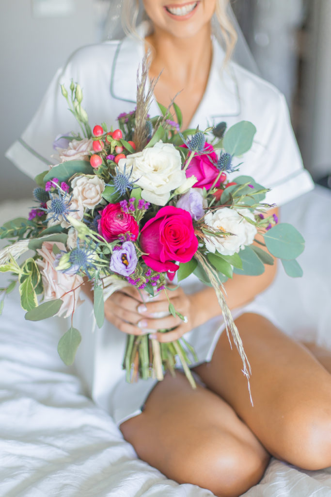 new jersey light and airy wedding photography of bride getting ready photos with pink bouquet 